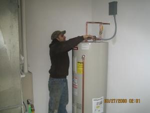 one of our Bowie water heater repair experets is repairing a broken unit